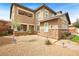 Two-story home with stone accents, desert landscaping, and covered porch at 5523 Kyle Peak Ct, Las Vegas, NV 89135
