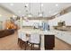 Open kitchen featuring a large island, modern appliances, and stylish pendant lighting at 5523 Kyle Peak Ct, Las Vegas, NV 89135