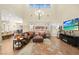 Bright, spacious living room featuring tall ceilings, comfortable seating, and stylish decor at 5523 Kyle Peak Ct, Las Vegas, NV 89135