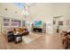 Spacious living room featuring high ceilings, elegant chandelier, and lots of natural light at 5523 Kyle Peak Ct, Las Vegas, NV 89135