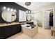 Beautiful main bathroom featuring dual sinks, an oversized tub, and a separate tiled shower with a glass enclosure at 5523 Kyle Peak Ct, Las Vegas, NV 89135