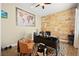 Modern office with a unique wood paneled wall, spacious desk, and comfortable seating, ideal for remote work at 5523 Kyle Peak Ct, Las Vegas, NV 89135