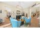 Inviting sitting area with comfortable blue chairs, bar area, and stylish decor at 5523 Kyle Peak Ct, Las Vegas, NV 89135