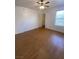 A bedroom featuring wood-look floors, a ceiling fan, and a window with blinds for natural light and privacy at 555 E Silverado Ranch Blvd # 1069, Las Vegas, NV 89183