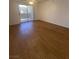 Spacious living room with hardwood floors and a sliding glass door to a balcony at 555 E Silverado Ranch Blvd # 1069, Las Vegas, NV 89183