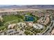 Expansive aerial view of the community showcasing the golf course, pool, and residential areas against a mountain backdrop at 5618 E San Marco Dr, Pahrump, NV 89061