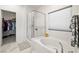 Well-lit bathroom featuring a bathtub, separate shower, and a view into the walk-in closet at 5618 E San Marco Dr, Pahrump, NV 89061