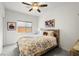Comfortable bedroom featuring soft carpet, a ceiling fan, and natural light from the windows at 5618 E San Marco Dr, Pahrump, NV 89061