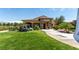 Charming clubhouse with stone accents, a tiled roof, and a serene outdoor seating area at 5618 E San Marco Dr, Pahrump, NV 89061
