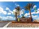Elegant entrance sign for Mountain Falls community surrounded by swaying palm trees and desert plants at 5618 E San Marco Dr, Pahrump, NV 89061