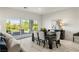 Bright dining room with sleek dark wood table, comfortable seating, and scenic outdoor view at 5618 E San Marco Dr, Pahrump, NV 89061