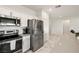Modern kitchen with stainless steel appliances, white cabinetry, subway tile, and adjacent breakfast bar at 5618 E San Marco Dr, Pahrump, NV 89061