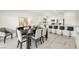 Bright open-concept kitchen and dining with barstool seating, stainless appliances, and modern decorative touches at 5618 E San Marco Dr, Pahrump, NV 89061