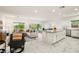 Bright, open-concept living area with marble floors, neutral décor, and seamless connection to the kitchen and outdoor spaces at 5618 E San Marco Dr, Pahrump, NV 89061