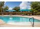 Large, inviting community pool with comfortable lounge chairs and shaded tables, ideal for enjoying sunny days at 5618 E San Marco Dr, Pahrump, NV 89061