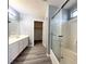 Bathroom features a shower-tub combination, large vanity and modern flooring at 5720 Ruby Creek Dr, Las Vegas, NV 89142