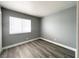 Cozy bedroom with hardwood style flooring and a window at 5720 Ruby Creek Dr, Las Vegas, NV 89142