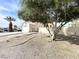 Drought resistant front yard with mature tree and partial view of the home at 5720 Ruby Creek Dr, Las Vegas, NV 89142