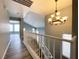 Bright hallway features modern chandelier, and leads to open area with plenty of natural light at 5720 Ruby Creek Dr, Las Vegas, NV 89142