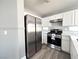Modern kitchen featuring stainless steel appliances and white cabinetry at 5720 Ruby Creek Dr, Las Vegas, NV 89142