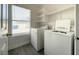 Functional laundry room with washer, dryer, and ample storage space at 5720 Ruby Creek Dr, Las Vegas, NV 89142