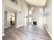 Open-concept living area with hardwood style floors, fireplace, and natural light at 5720 Ruby Creek Dr, Las Vegas, NV 89142