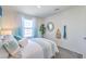 Bright bedroom featuring stylish bedding, natural light, and decor for comfort at 6112 Aster Garden St # 131, North Las Vegas, NV 89081