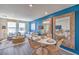 Bright dining area with modern furnishings, a trendy blue accent wall, and an inviting open layout at 6112 Aster Garden St # 131, North Las Vegas, NV 89081
