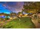 Lush backyard featuring a putting green, pool, and manicured landscaping, ideal for recreation at 62 Grand Masters Dr, Las Vegas, NV 89141