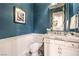 A stylish bathroom featuring textured blue wallpaper, marble countertop, and decorative mirror at 62 Grand Masters Dr, Las Vegas, NV 89141