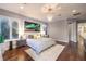Bright bedroom featuring hardwood floors, a chandelier, and gray walls at 62 Grand Masters Dr, Las Vegas, NV 89141