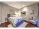 Comfortable bedroom featuring hardwood floors, gray walls, TV, and stylish decor at 62 Grand Masters Dr, Las Vegas, NV 89141