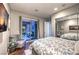 Bright bedroom with mirrored closet doors and sliding door access to courtyard at 62 Grand Masters Dr, Las Vegas, NV 89141
