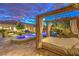 Luxurious outdoor cabana with daybed overlooking the pool and manicured lawn at 62 Grand Masters Dr, Las Vegas, NV 89141
