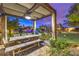 Charming outdoor dining space with ample seating, set amidst a beautifully landscaped backyard at 62 Grand Masters Dr, Las Vegas, NV 89141