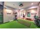 Inviting entertainment room with golf simulator, neutral walls, and bright lighting at 62 Grand Masters Dr, Las Vegas, NV 89141