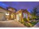Charming home with stone accents, three car garage and elegant arched entryway at 62 Grand Masters Dr, Las Vegas, NV 89141