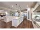 Open-concept kitchen with dual islands, stainless steel appliances, and seamless flow to the living room at 62 Grand Masters Dr, Las Vegas, NV 89141