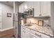 A kitchenette with stainless steel appliances and granite countertops at 62 Grand Masters Dr, Las Vegas, NV 89141