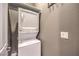 A stackable white washer and dryer in a well-lit laundry area at 62 Grand Masters Dr, Las Vegas, NV 89141