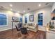 Comfortable living room with a couch, chairs, and large windows at 62 Grand Masters Dr, Las Vegas, NV 89141