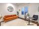 Bright home office with a comfortable orange couch and modern desk at 62 Grand Masters Dr, Las Vegas, NV 89141