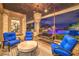 Cozy patio with hanging swing chair, seating area, and outdoor lighting near pool at 62 Grand Masters Dr, Las Vegas, NV 89141