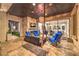 Beautiful stone patio with hanging swing, fireplace, and view to living room at 62 Grand Masters Dr, Las Vegas, NV 89141