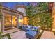 Private patio with comfortable lounge seating and view of the well-manicured yard and cozy bedroom at 62 Grand Masters Dr, Las Vegas, NV 89141