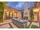 Cozy outdoor patio with a stone fireplace and comfortable seating for relaxing evenings at 62 Grand Masters Dr, Las Vegas, NV 89141