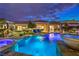 Inviting pool and spa with bar and lounge area, all beautifully lit at night at 62 Grand Masters Dr, Las Vegas, NV 89141