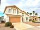 Attractive two-story home featuring a two-car garage, tile roof, and well-kept landscaping at 66 John Stuart Mill St, Henderson, NV 89002