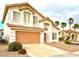 Charming two-story home featuring a tile roof, manicured landscaping, and an attached two-car garage at 66 John Stuart Mill St, Henderson, NV 89002