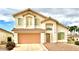 Charming two-story home with a tile roof, two-car garage, and manicured landscaping at 66 John Stuart Mill St, Henderson, NV 89002